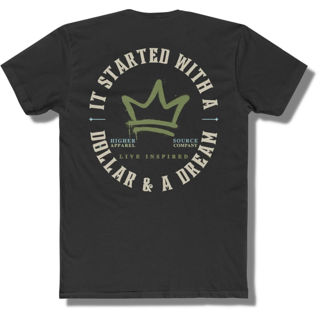 Back side of a black t shirt with a circular logo that says it started with a dollar and a dream in pastel grey. There is a mustard green crown in the center of the logo and live inspired below.