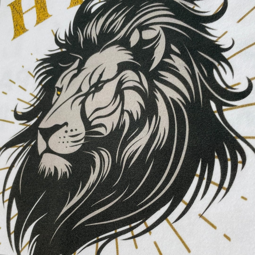 A close up of a large lion's head on the front of a white higher source apparel t shirt