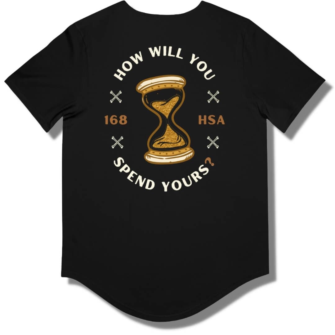 Back side of a black curved hem t shirt with "how will you spend yours" in an oval shape. The font is in off white and gold with an hour glass in the center.