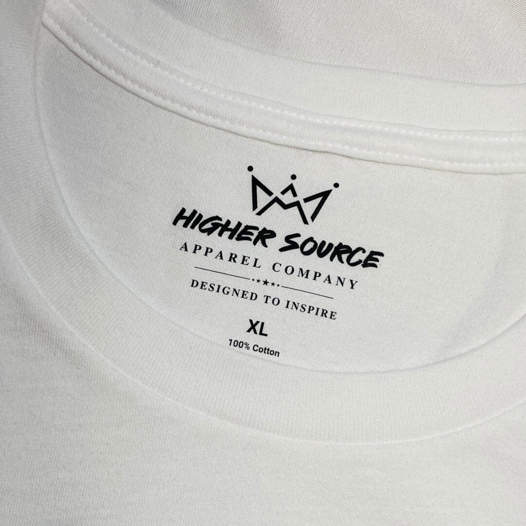 A close up of a higher source neck tag and collar. The label says designed to inspire in black font