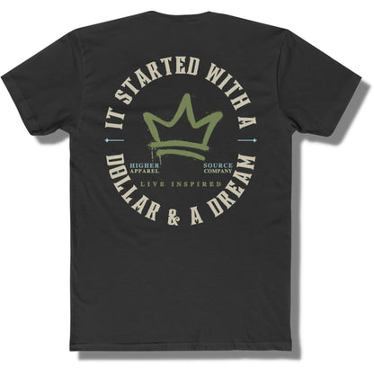 Back side of a black t shirt with a circular logo that says it started with a dollar and a dream in pastel grey. There is a mustard green crown in the center of the logo and live inspired below.