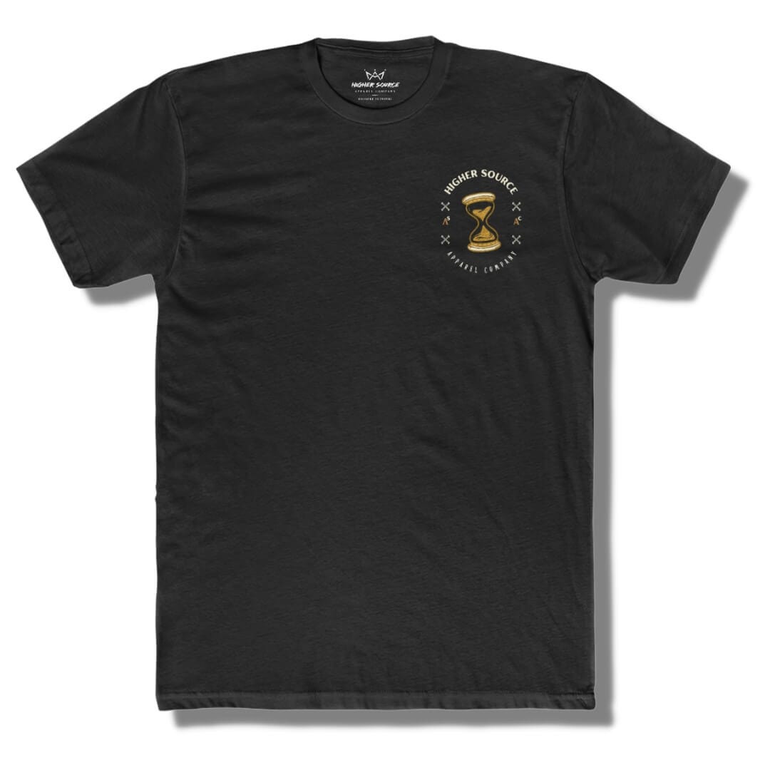 Front side of a black t shirt with higher source logo in white font and a gold hour glass in the upper left breast area.