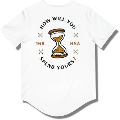Back side of a white curved hem t shirt with "how will you spend yours" in an oval shape. The font is in black and gold with an hour glass in the center.