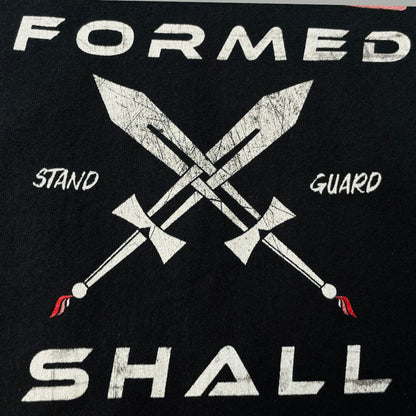 A close up image of a black higher source apparel t shirt with two swords crossed in the center with stand guard in white font.
