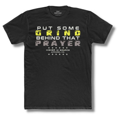 Front side of a black higher source apparel t shirt with “put some grind behind that prayer” in white, maximum yellow, and taupe gray font.