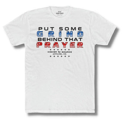 Front side of a white higher source apparel t shirt with “put some grind behind that prayer” in red black and blue font.