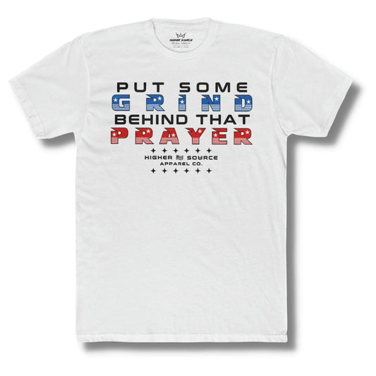 Front side of a white higher source apparel t shirt with “put some grind behind that prayer” in red black and blue font.
