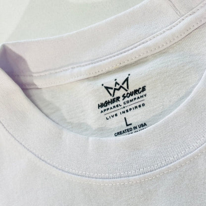 A close up of a higher source neck tag and collar. The label says designed to inspire in black font