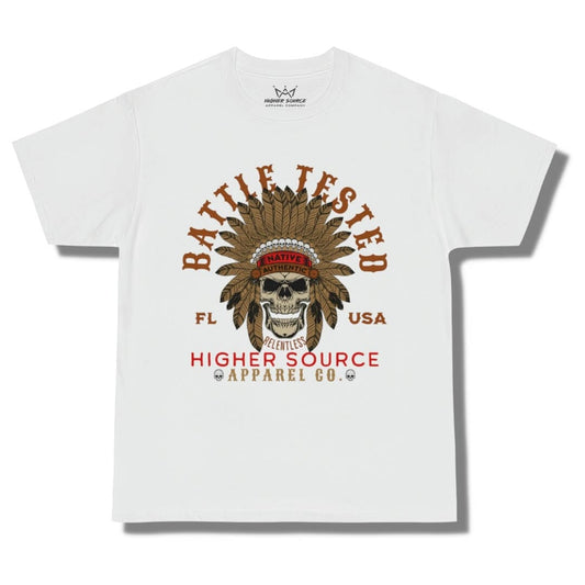 Front side of a white oversized higher source apparel t shirt with battle tested in large brown font and an apache skull in the center. Higher Source apparel company is at the bottom in red and dark vanilla font.