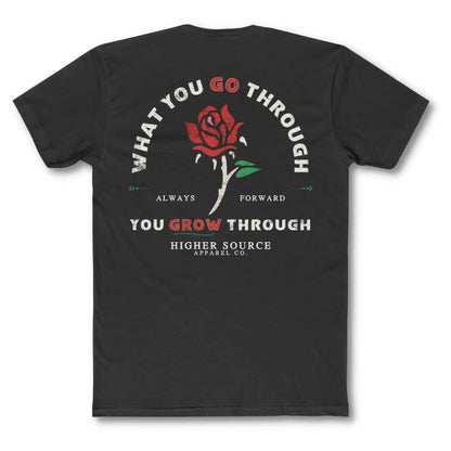 Back side of a black higher source apparel t shirt with “what you go through, you grow through in pastel grey and lava red font. There is a lava red and green rose in the center of the logo.