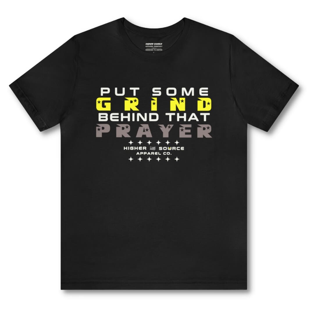 Front side of a black higher source apparel women's t shirt with “put some grind behind that prayer” in white, maximum yellow, and taupe gray font. 