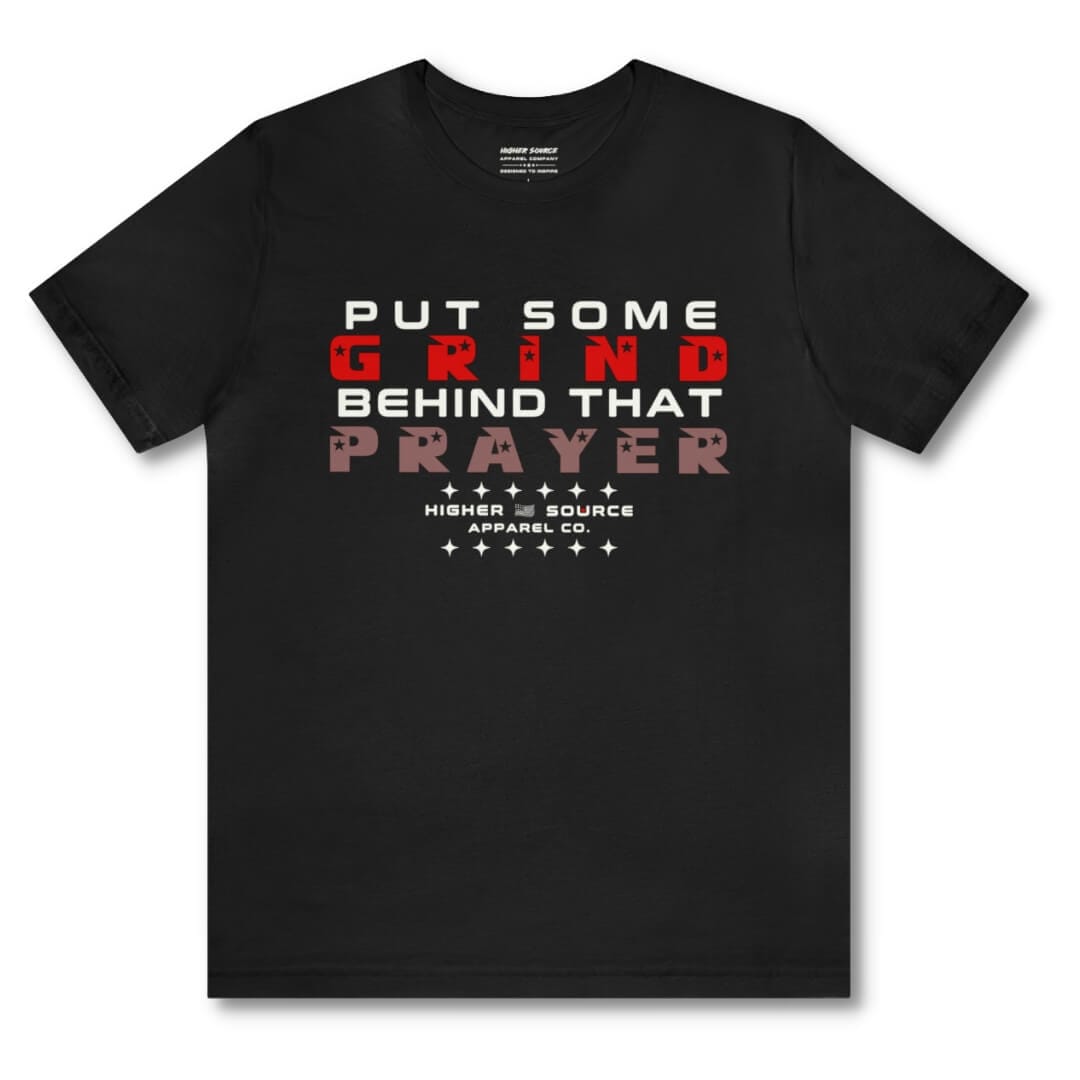 Front side of a black higher source apparel women's t shirt with “put some grind behind that prayer” in white, rosso corsa red, and copper rose font.